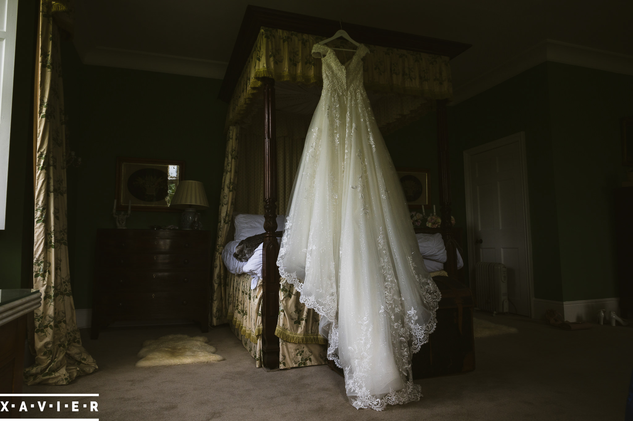 wedding dress hangs on the bed