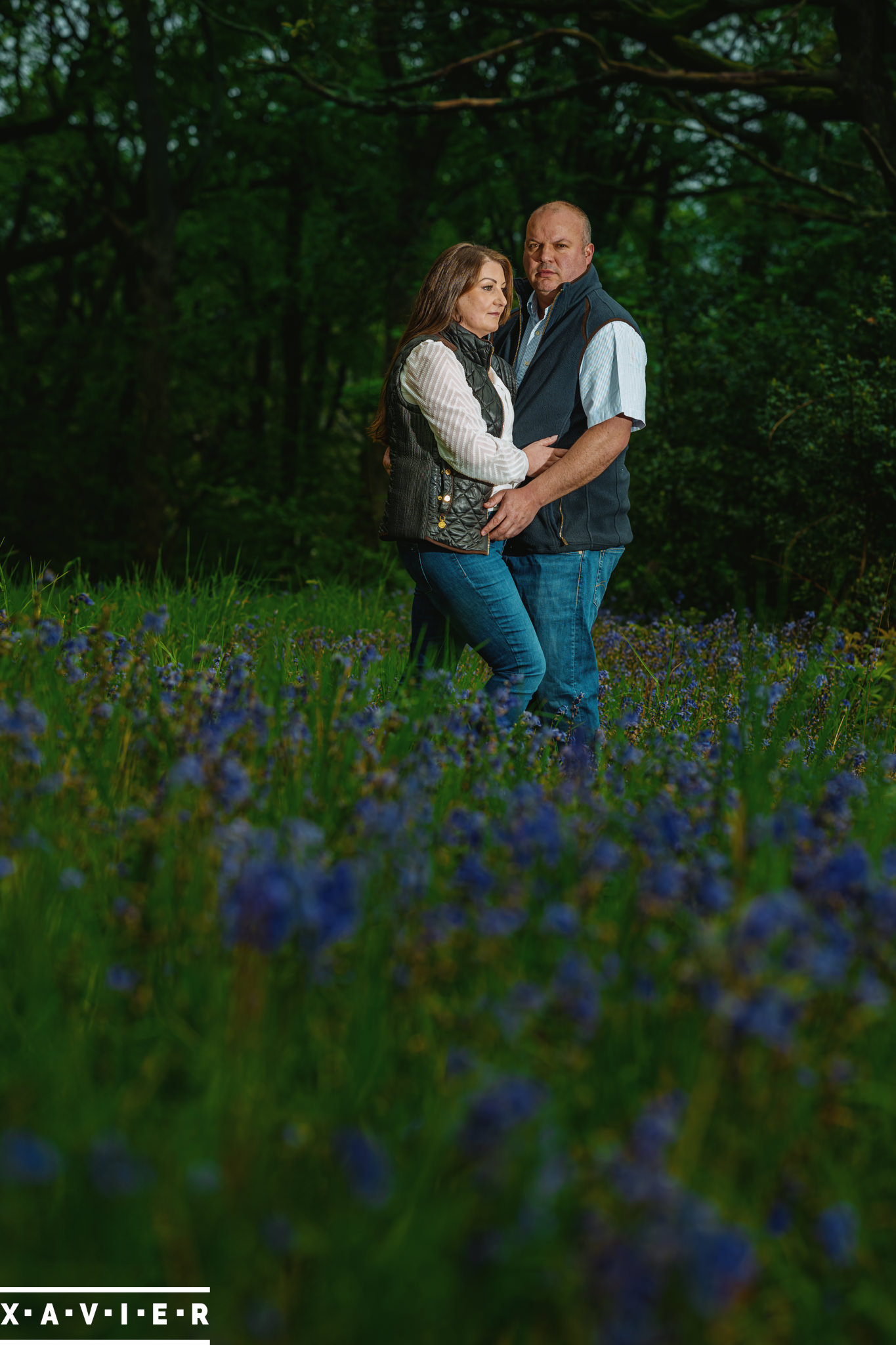 couple pose during connection engagement photos in bluebell wood