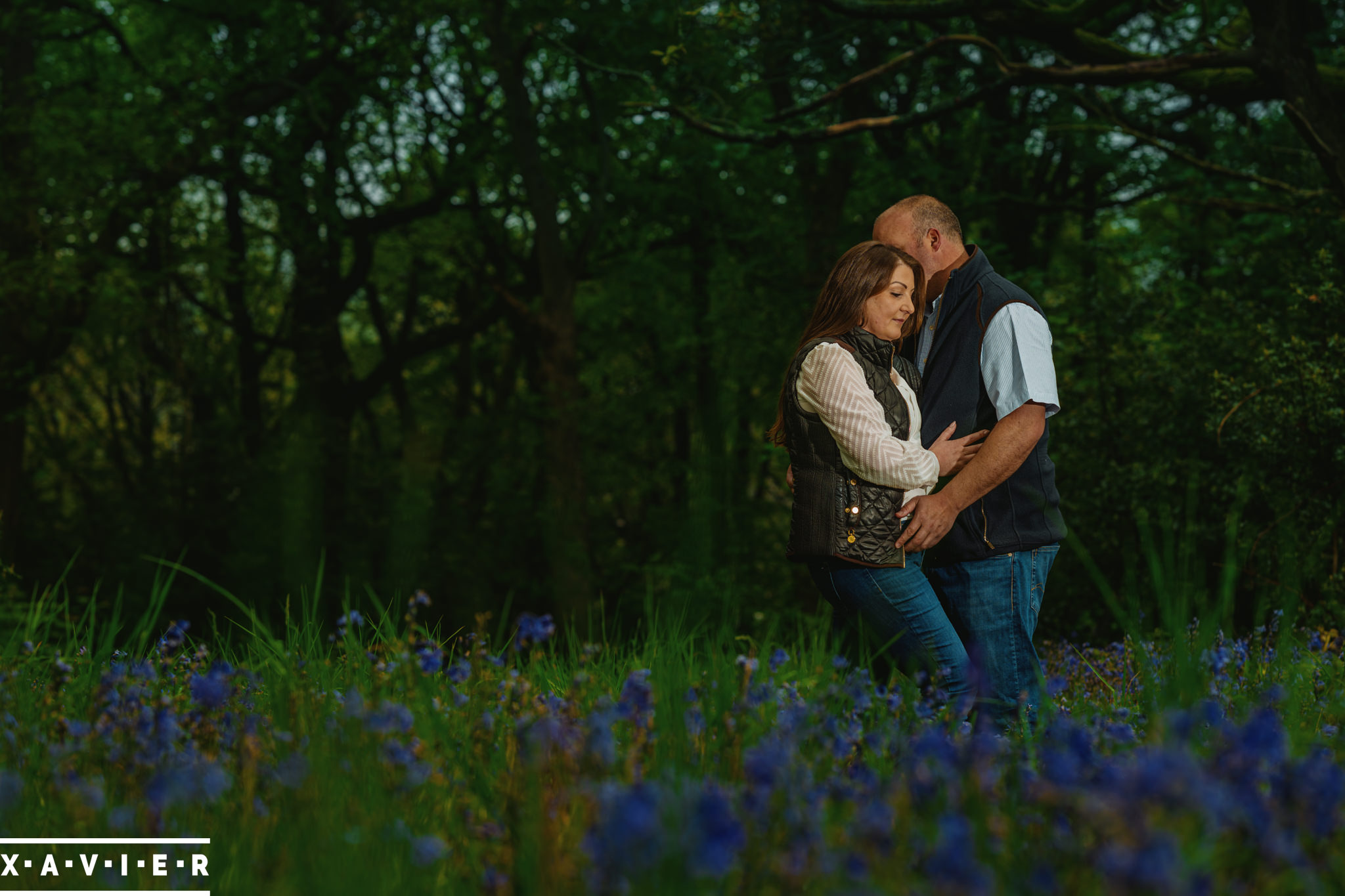 romantic engagement photography posing amongst bluebells