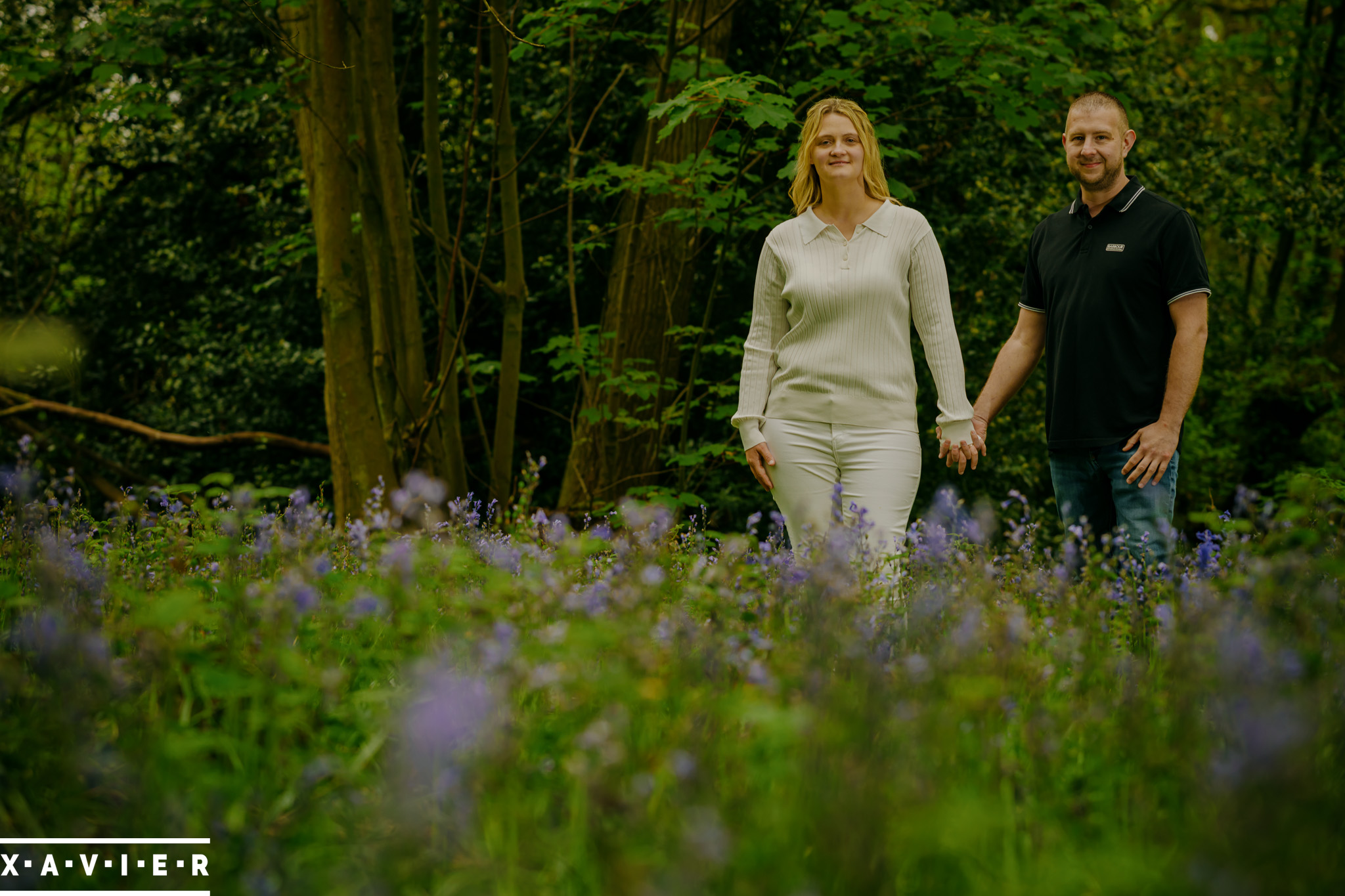 engagement photography with couple hold hands in wentworth bluebell wood
