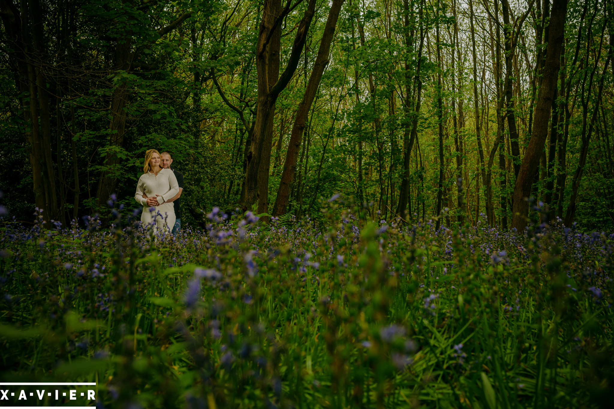 engagement couple standing in wentworth bluebell wood