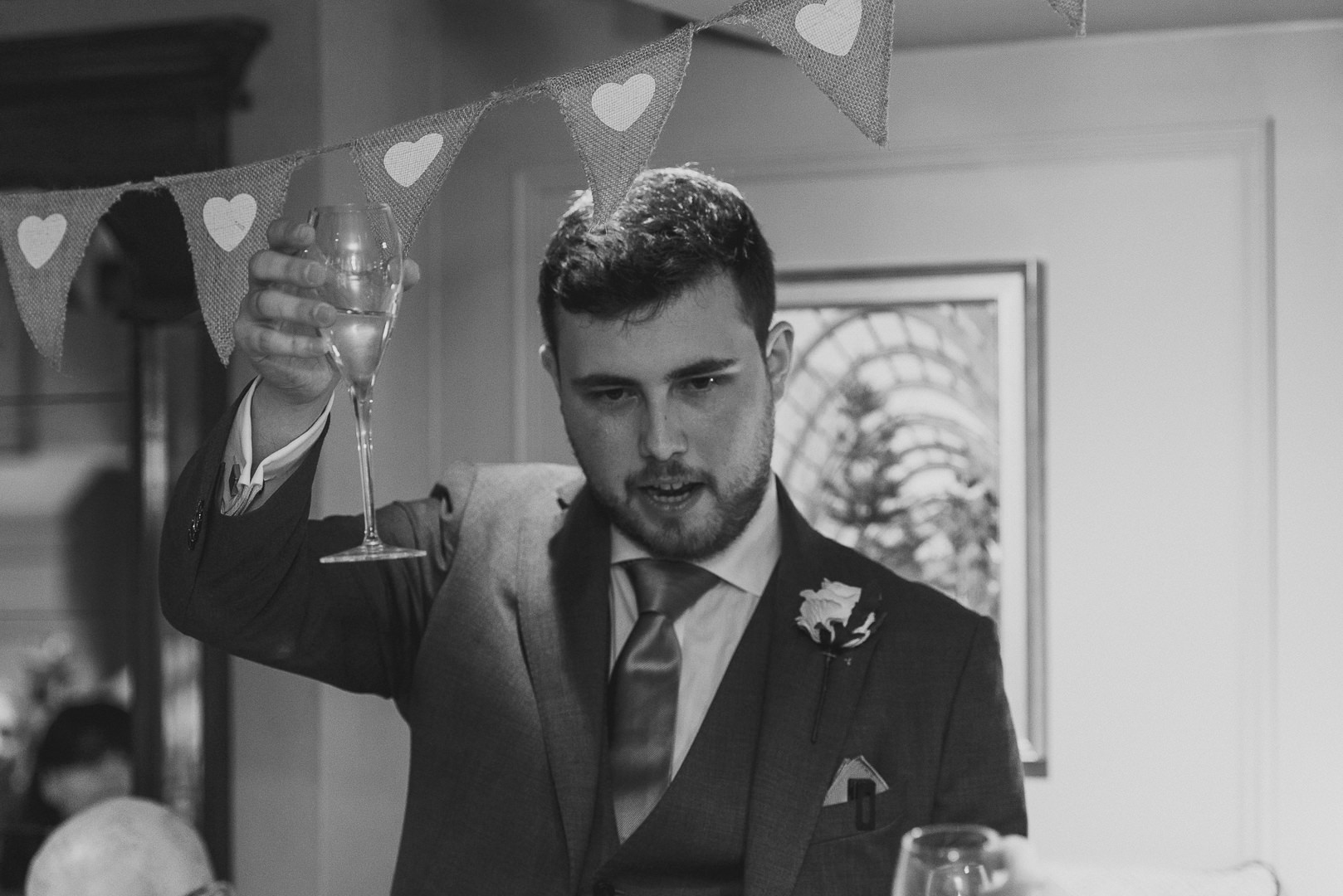 the groom raises his glass