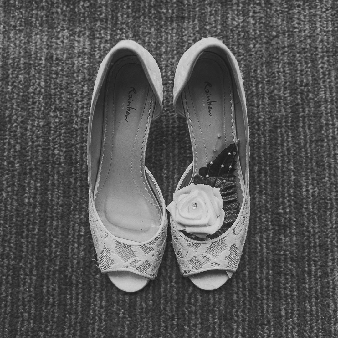 image looks down on the brides wedding shoes