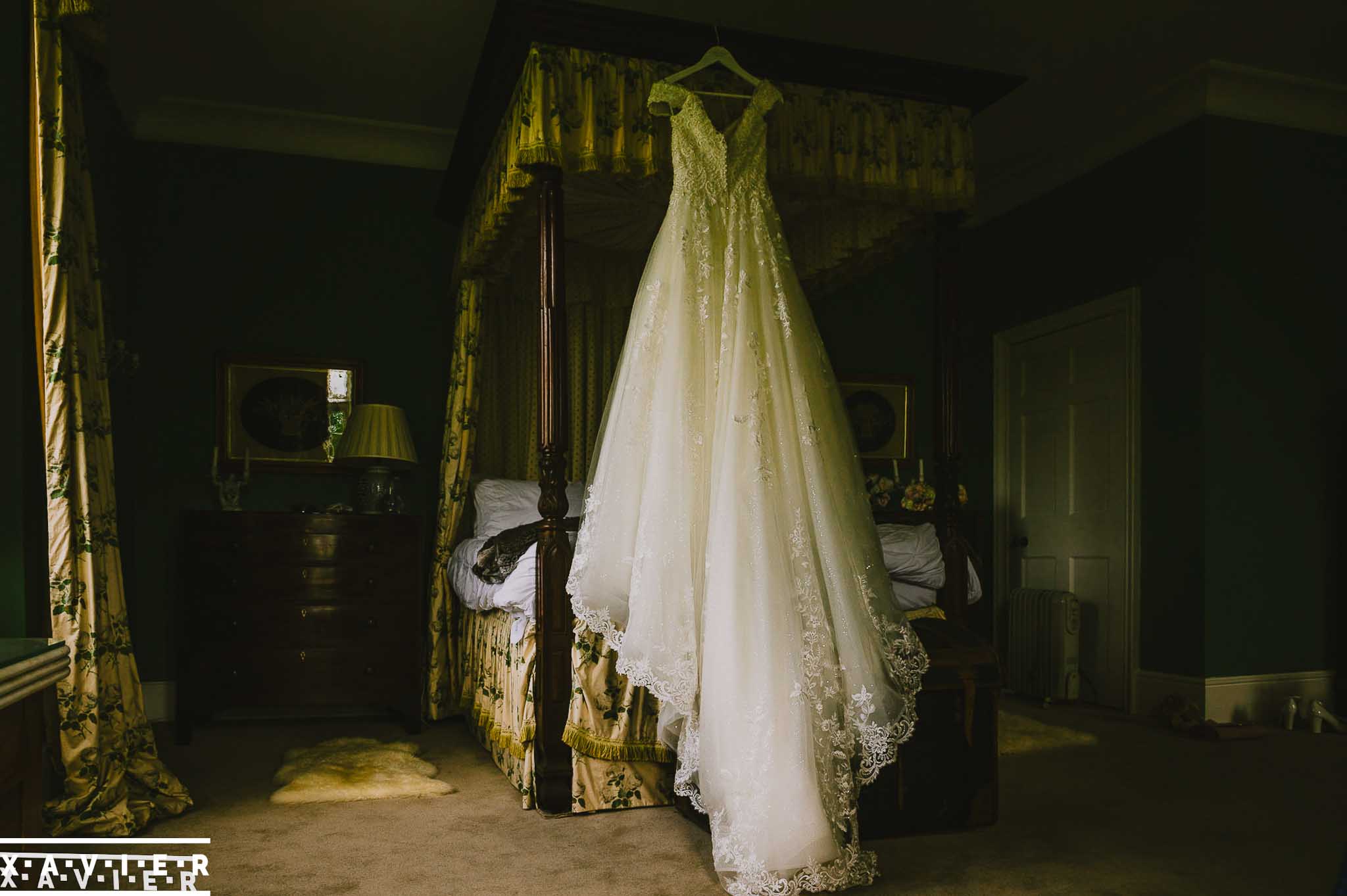 wedding dress hangs in the dressing room