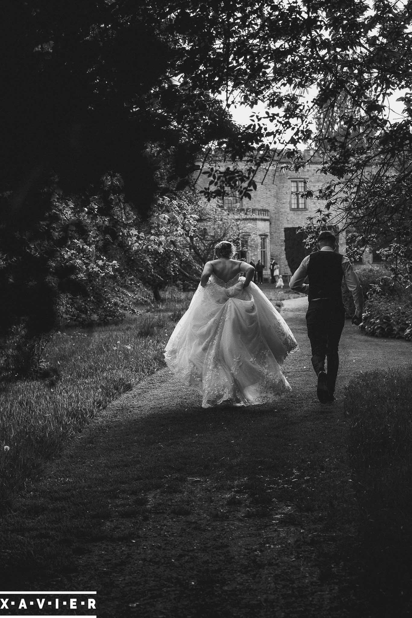 Bride and groom walking in the gardens