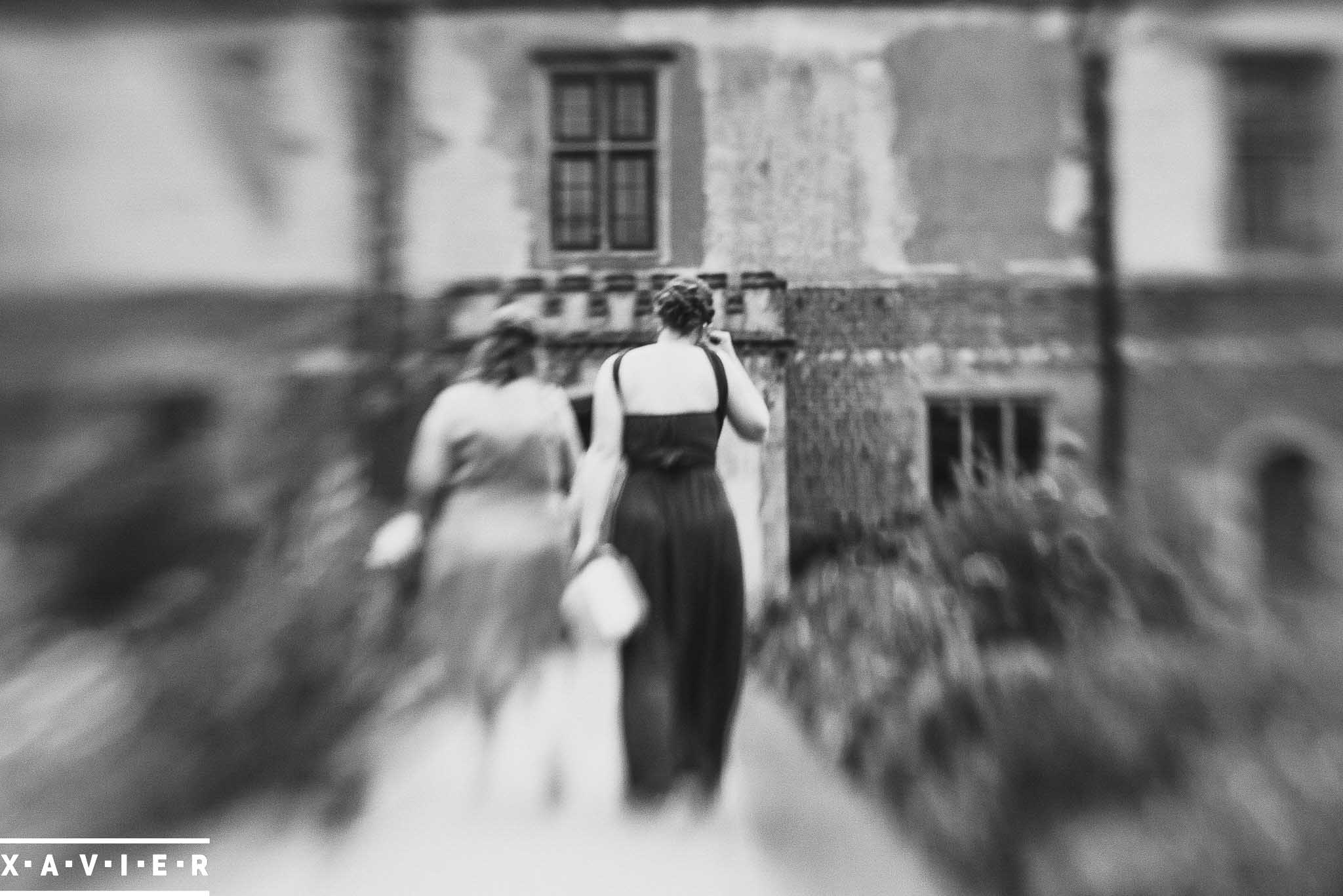 creative shot of bridesmaids walking in the courtyard