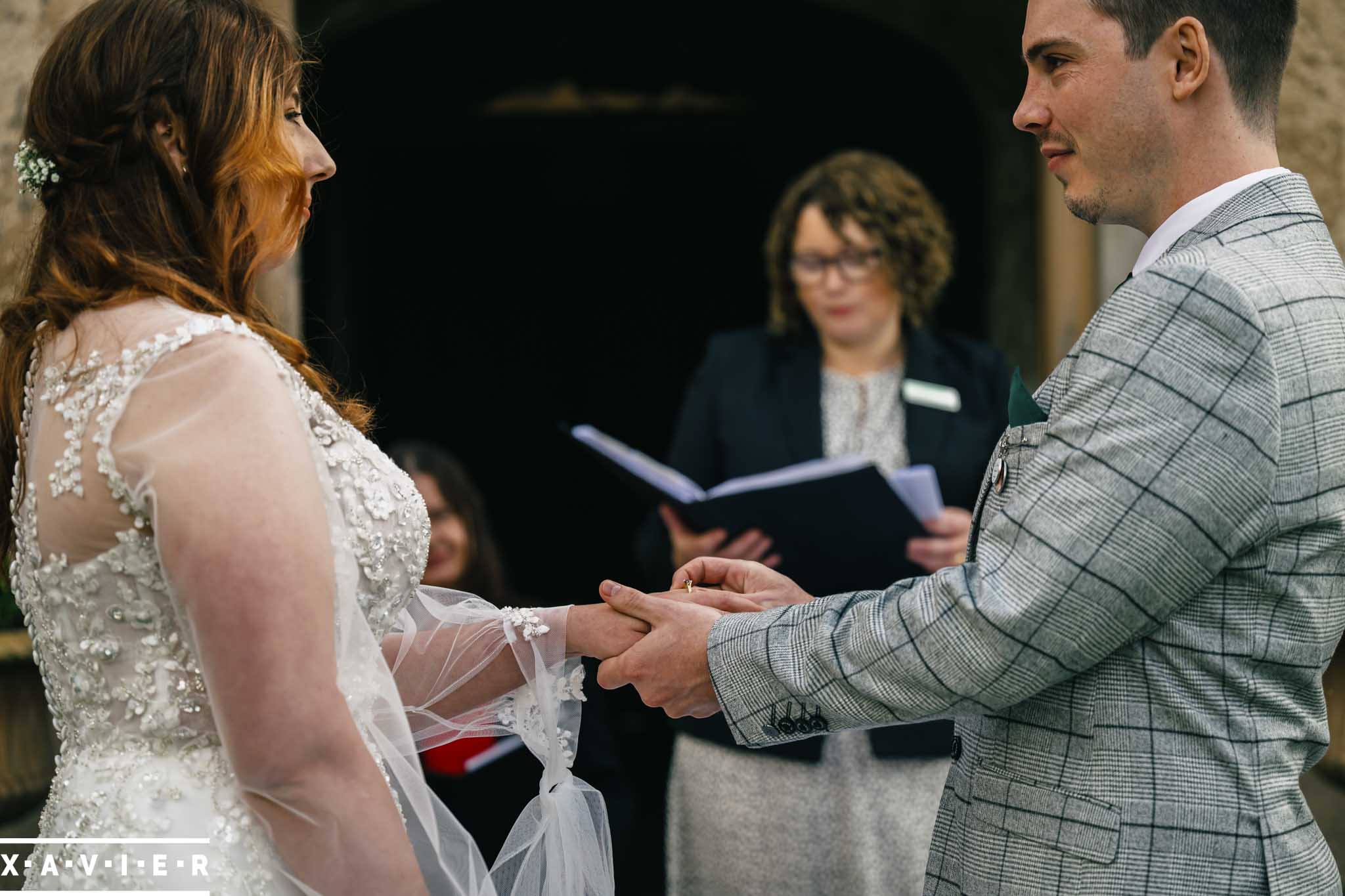 a guest holds the brides veil ater it blew off