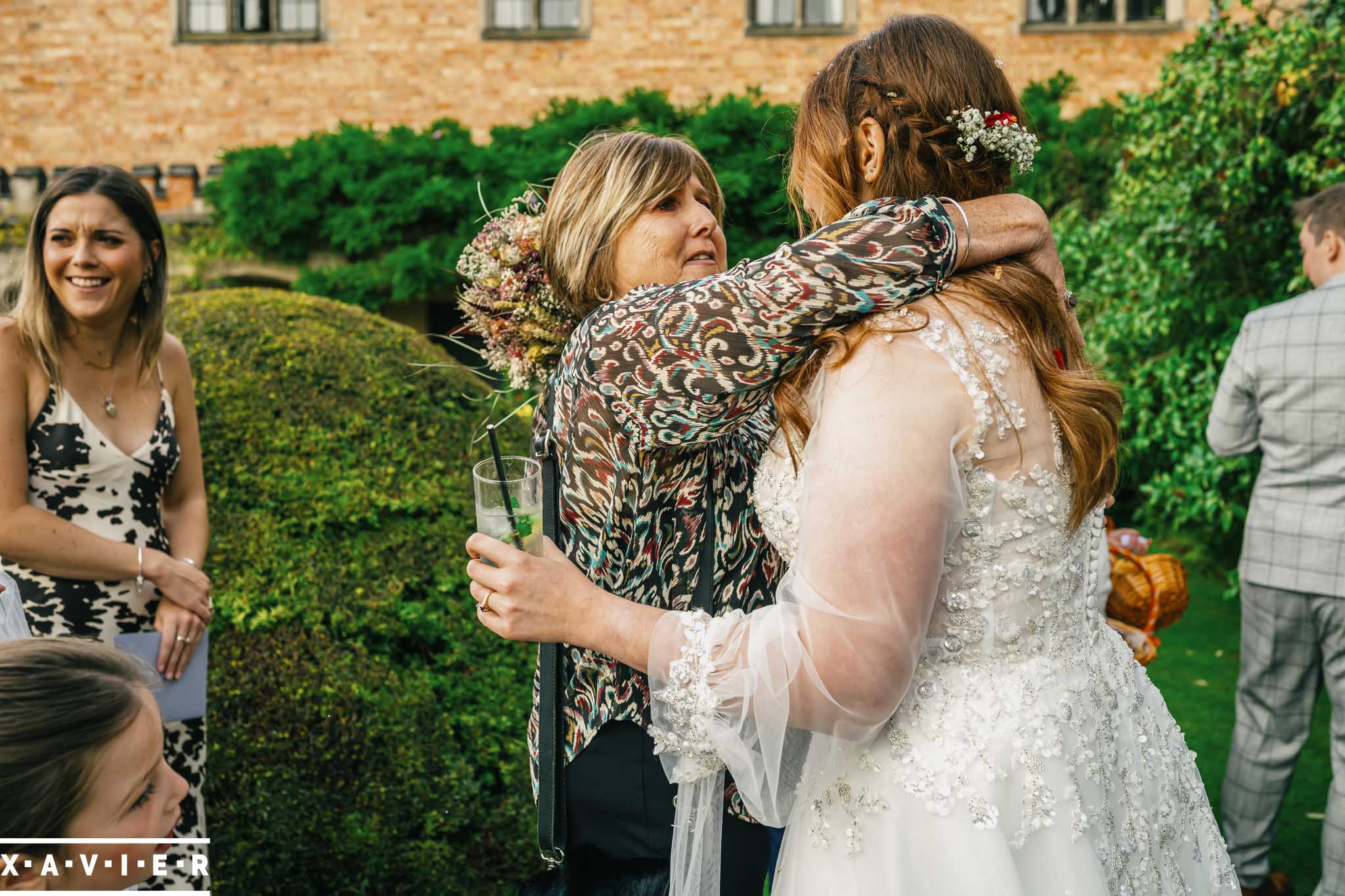 Flowergirl laughs excitedly as she greets the bride