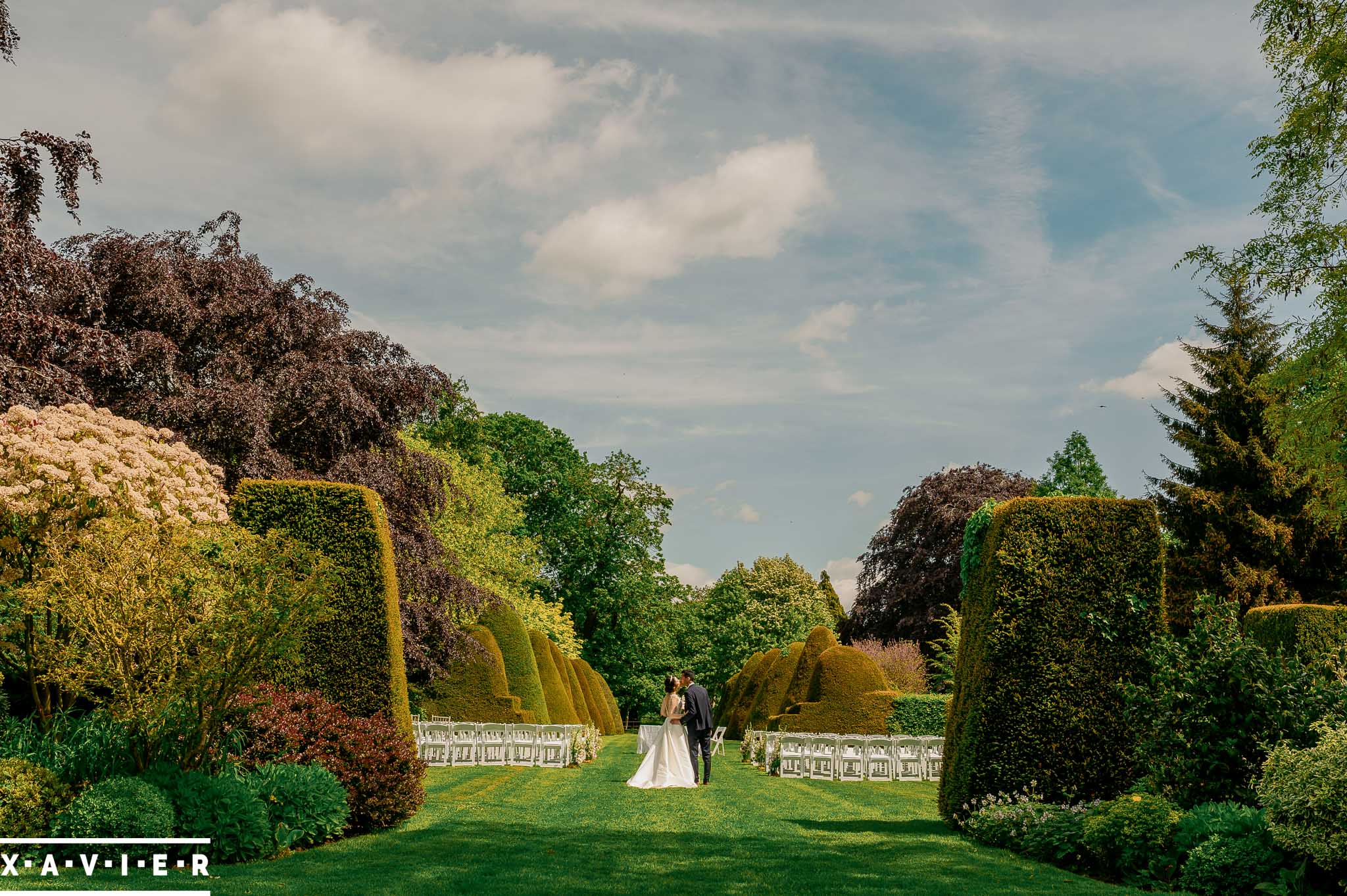 bride and groom walk in the gardens
