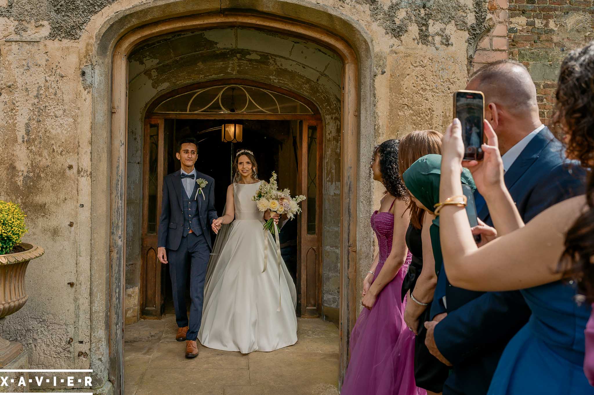 Bride and groom walk to their guests as husband and wife
