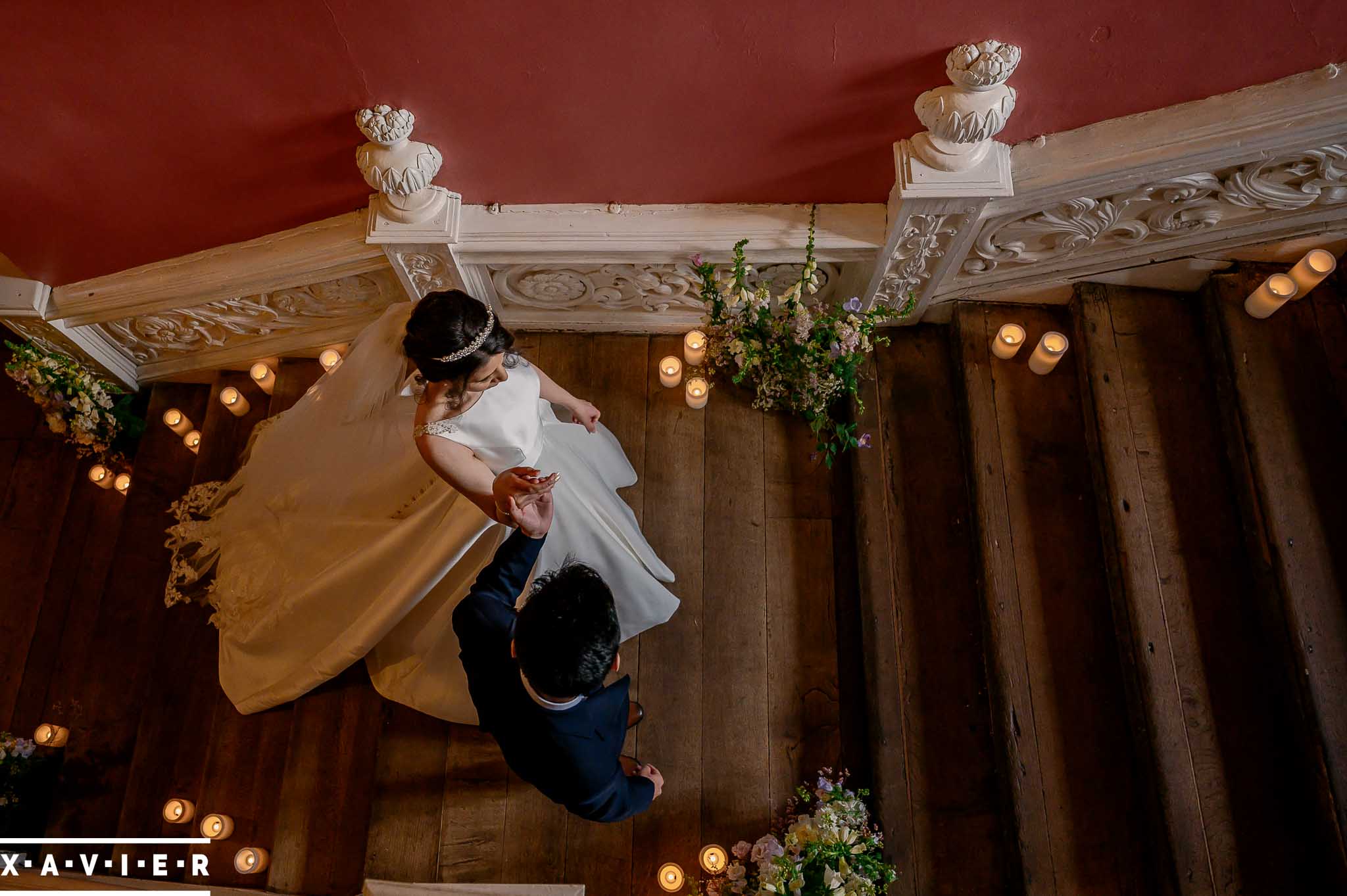 groom leads the bride up the stairs