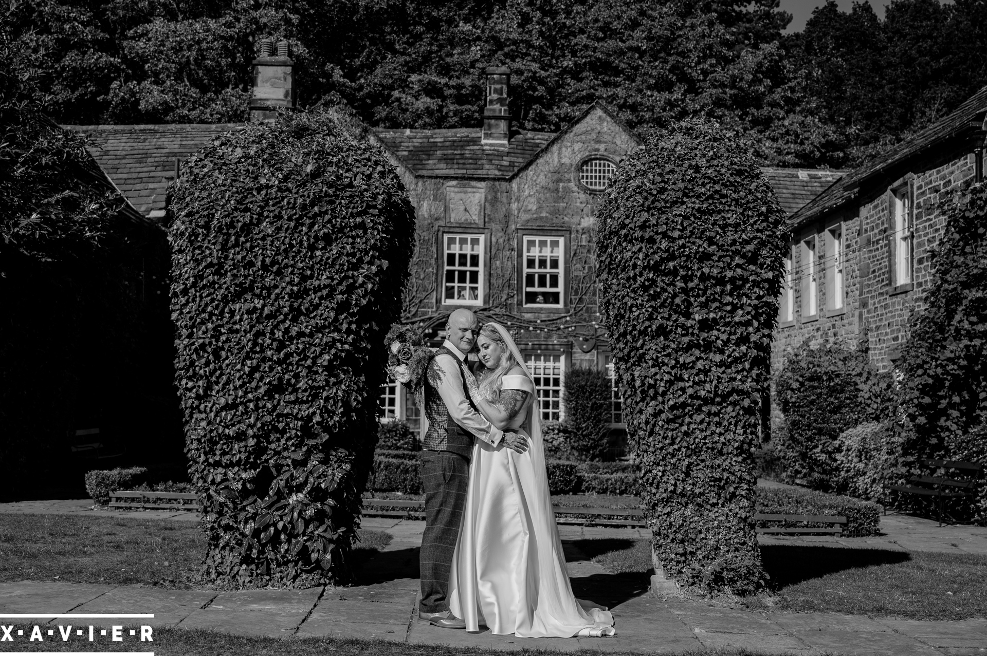 bride and groom stand in the gardens at whitley hall hotel