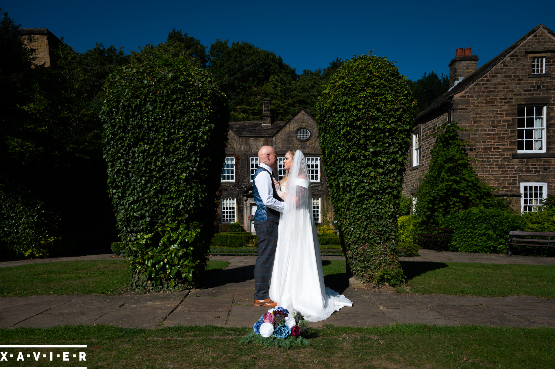 bride and groom stand together in the garden
