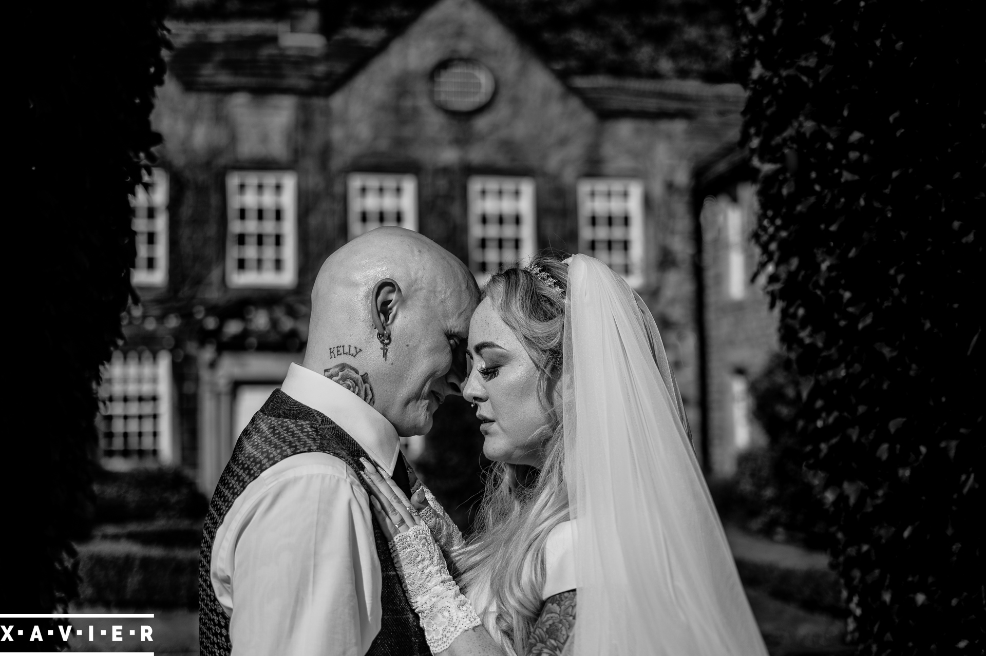 black and white close up photo of bride and groom in garden 