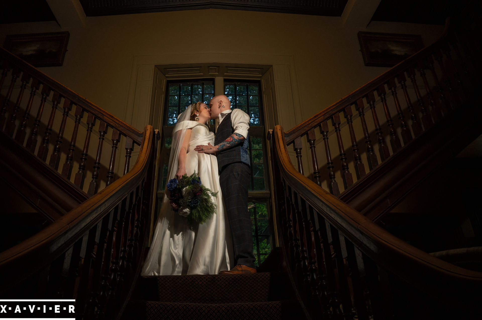 bride and groom kiss on the stairs