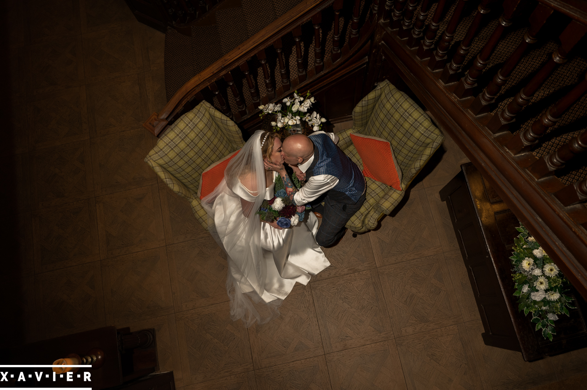 view from above as bride and groom kiss