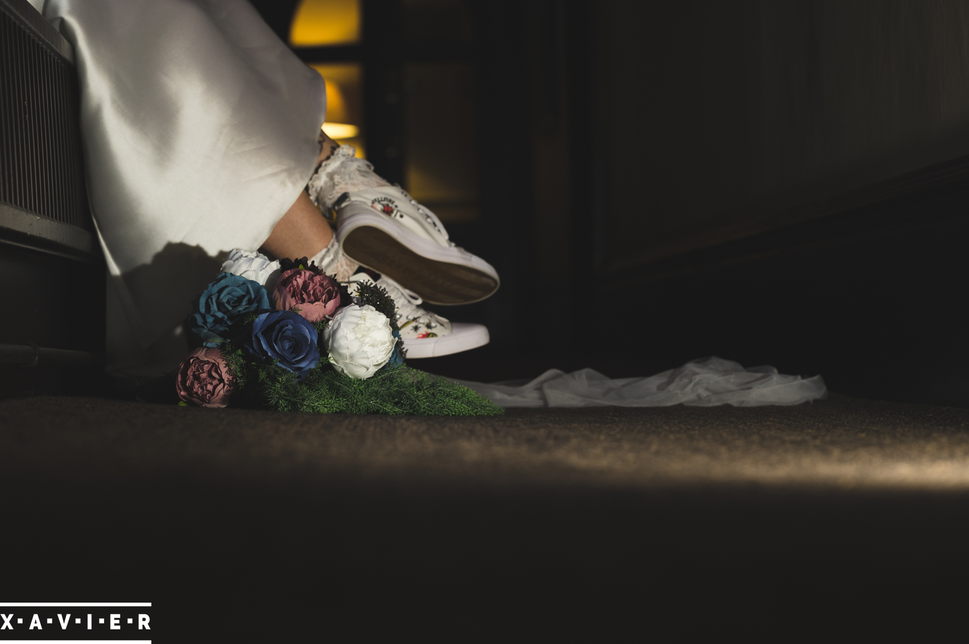 photo of brides converse trainers and wedding flowers