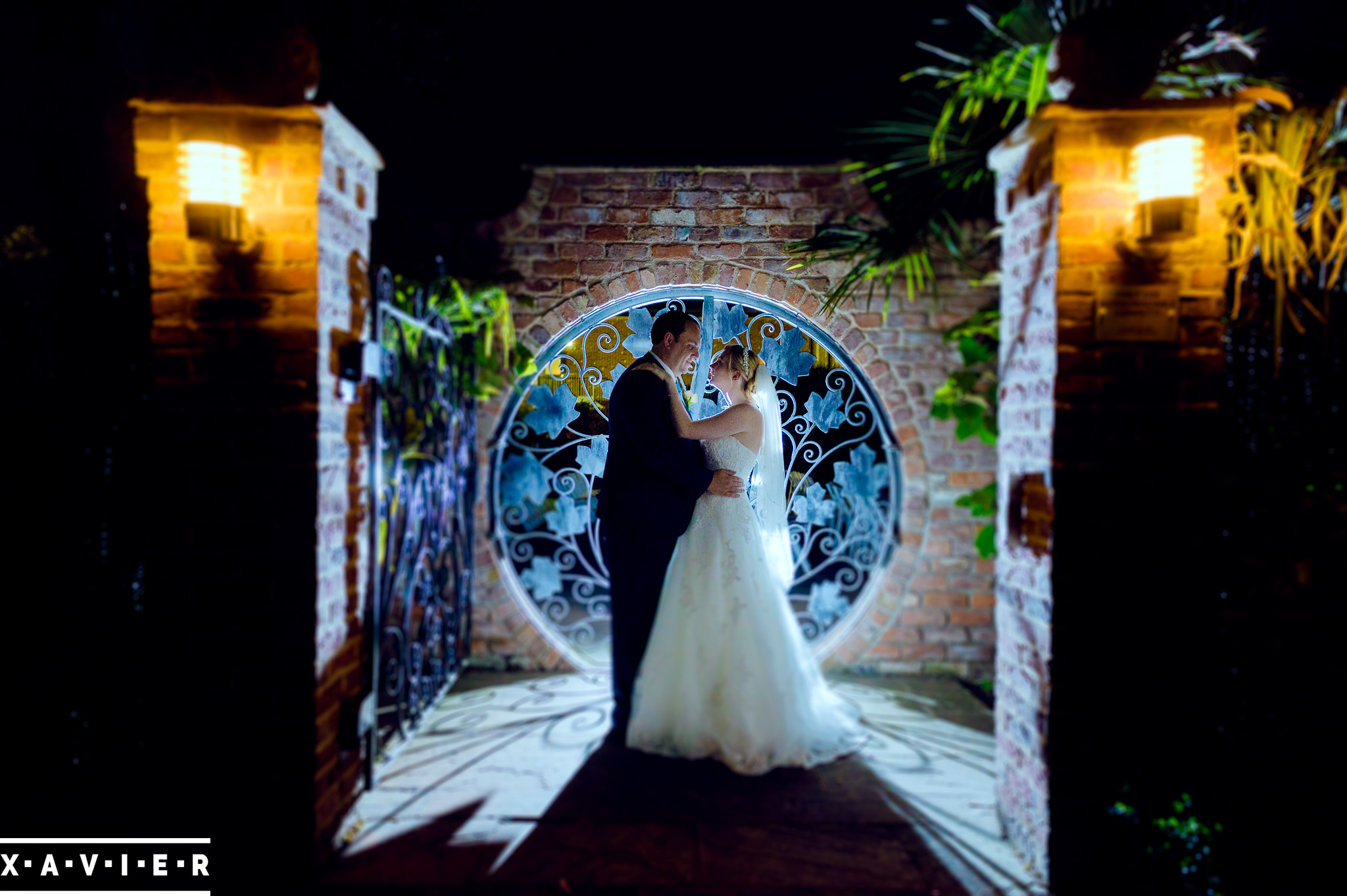 bride and groom embrace at night