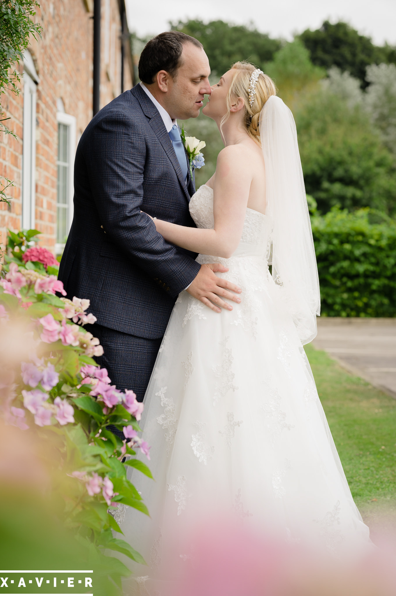 bride and groom kiss in the gardens