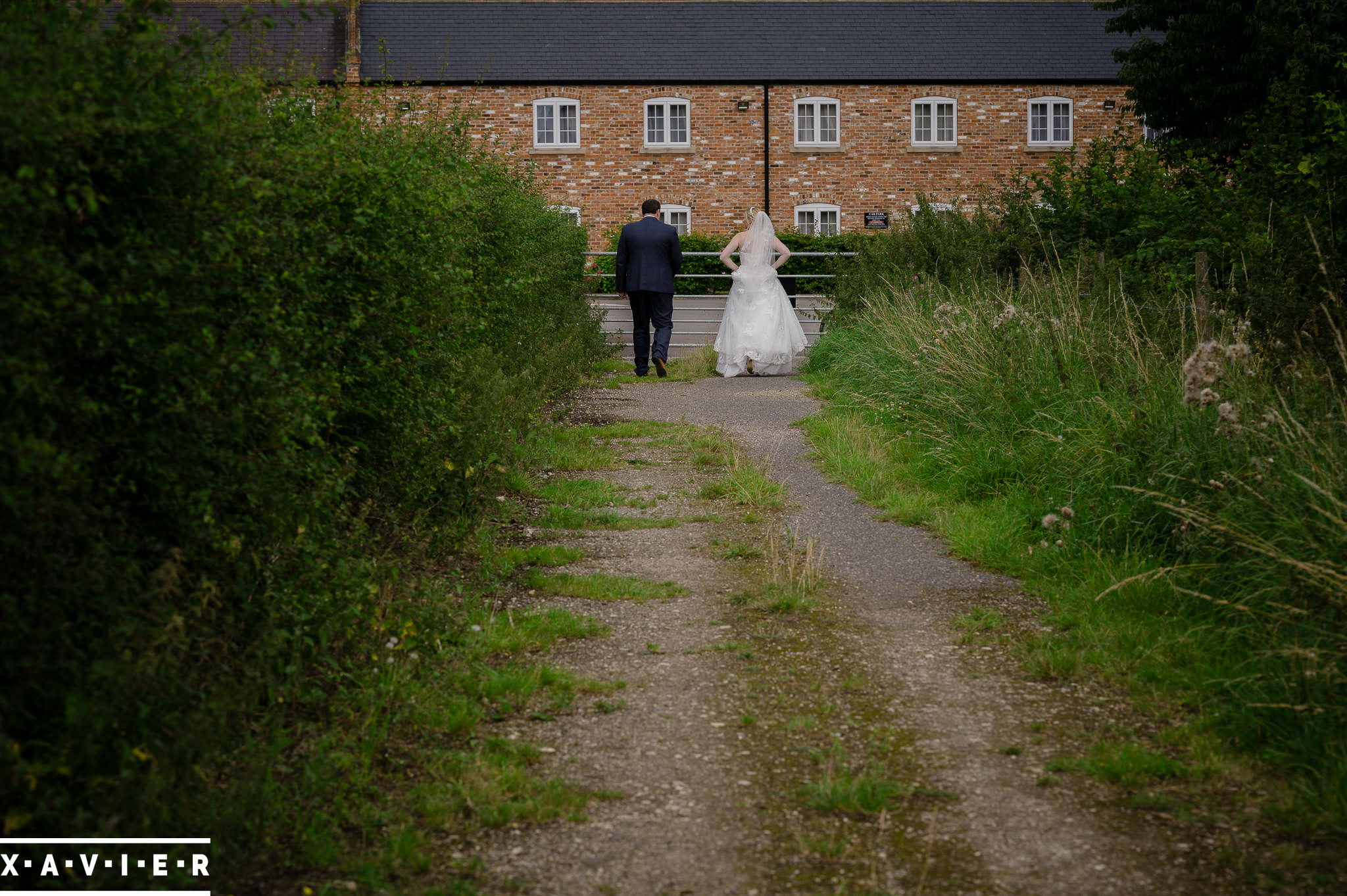 bride and groom walk down the lane