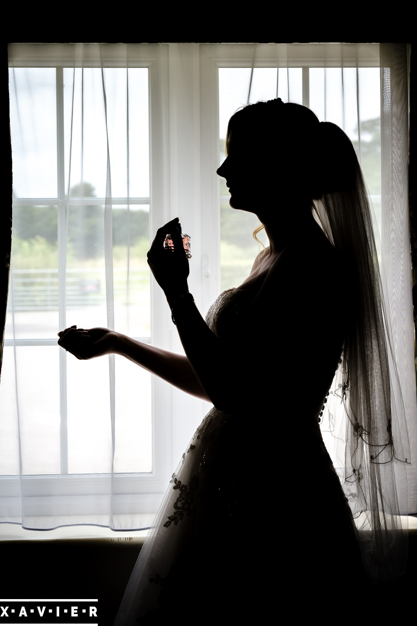 bride putting on her perfume