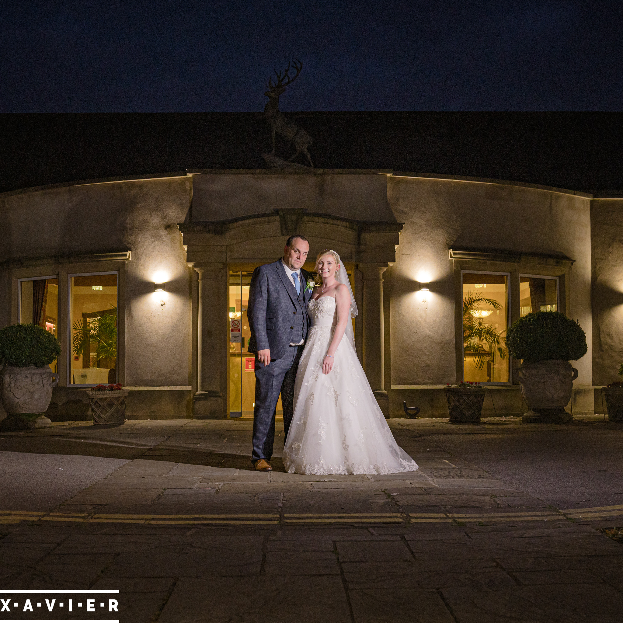 bride and groom pose at night