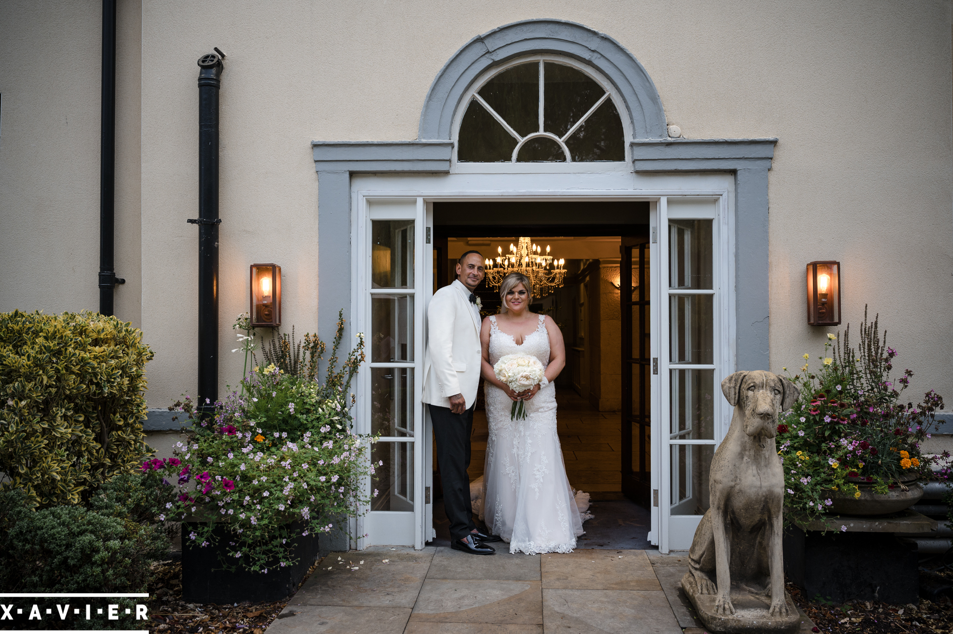 bride and groom stand in the hotel doorway