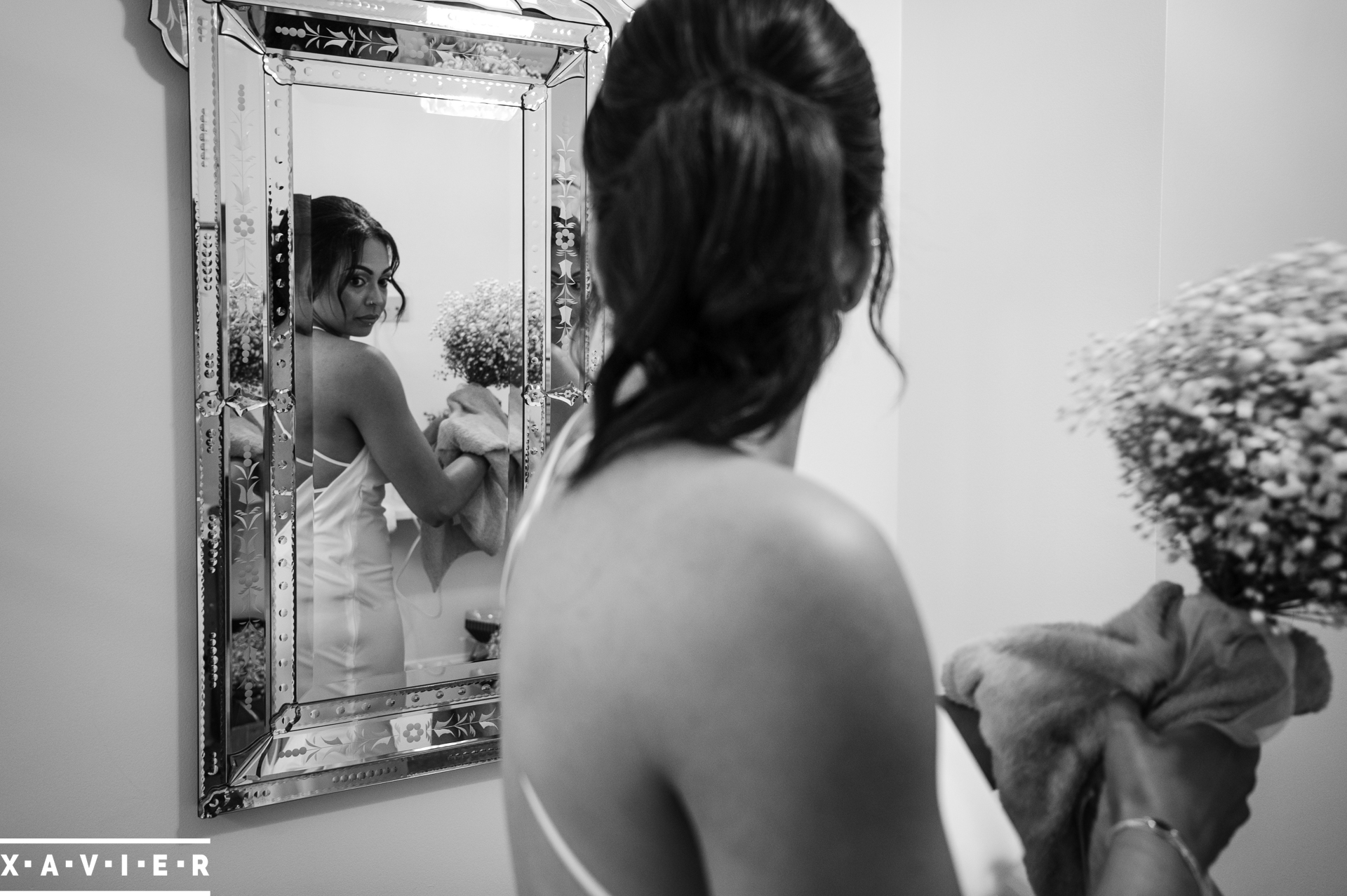 bridesmaid checks her dress in the mirror