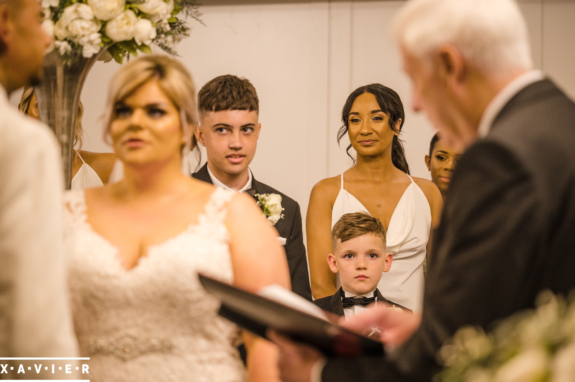 pageboys look on at the ceremony