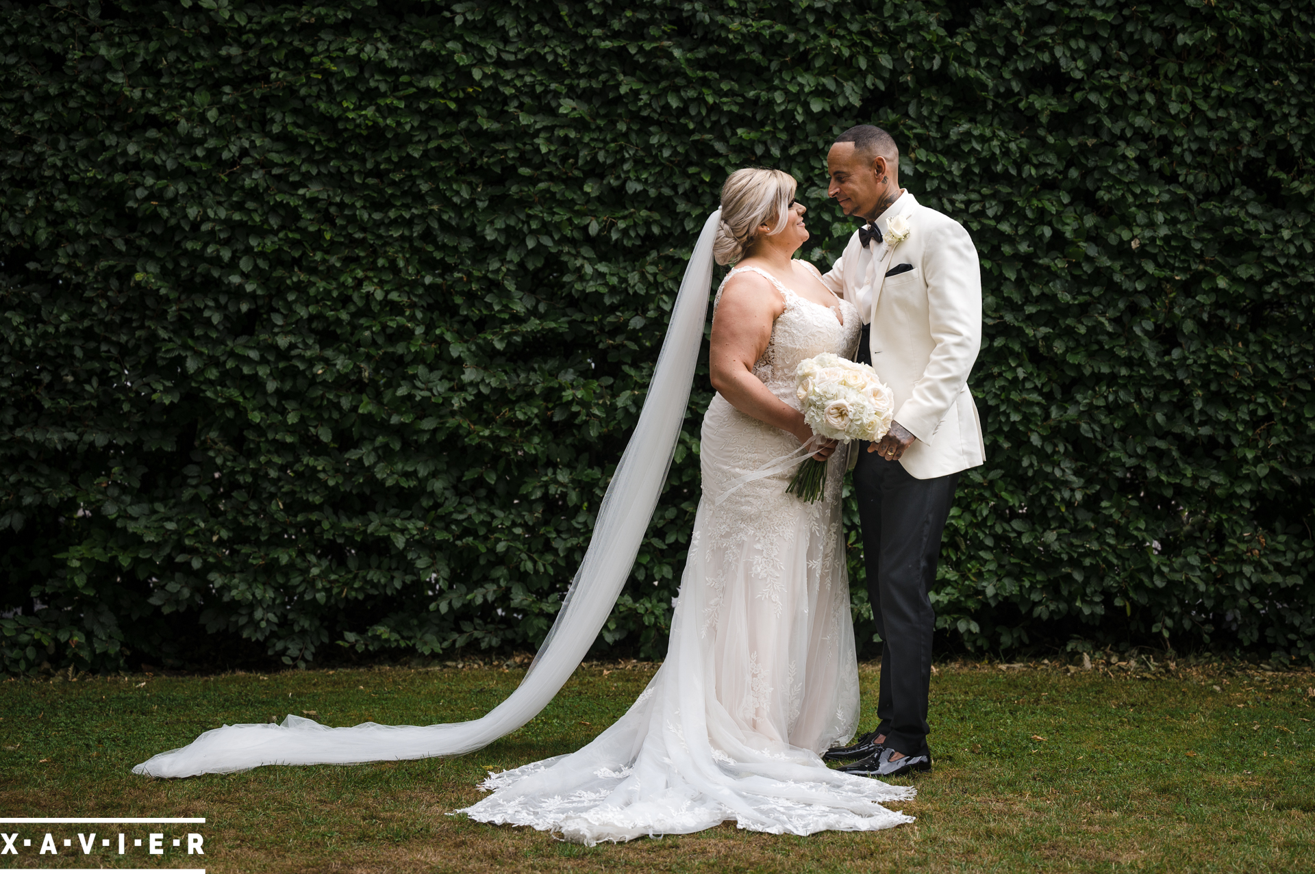 bride and groom hold each other in the garden