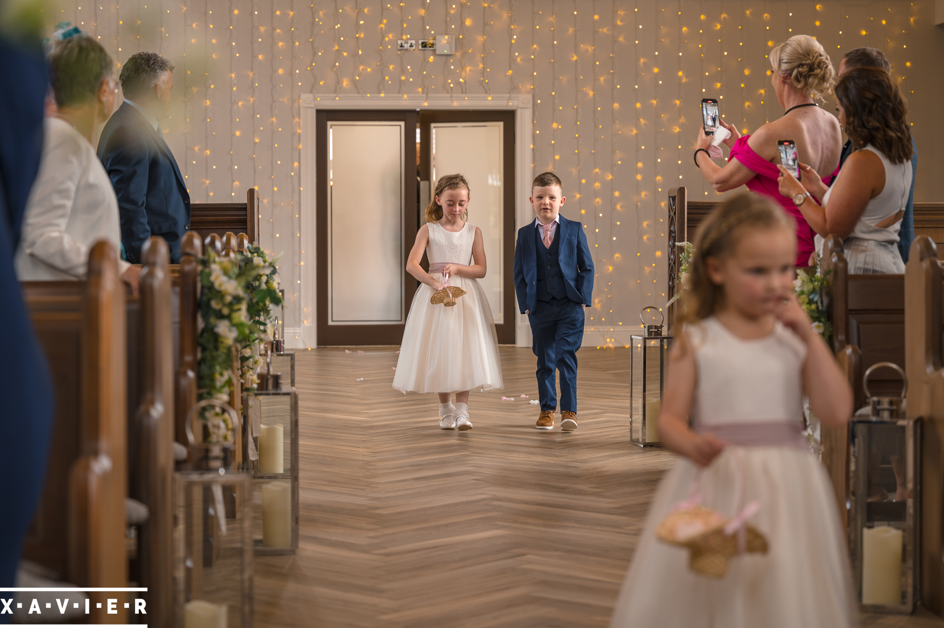 pageboy and flowergirl walk down the aisle
