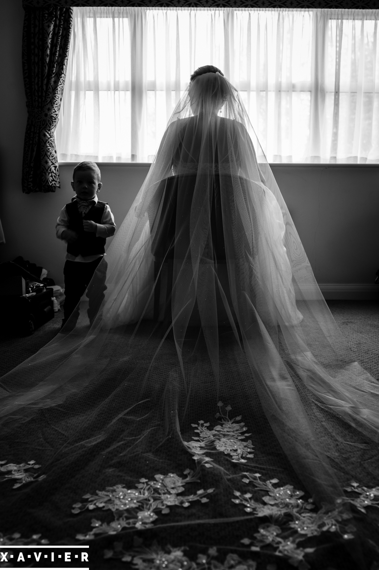 brides veil is laid out behind her