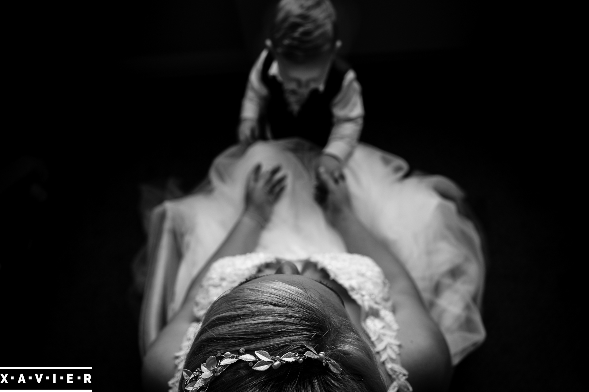 bride looking down at young son