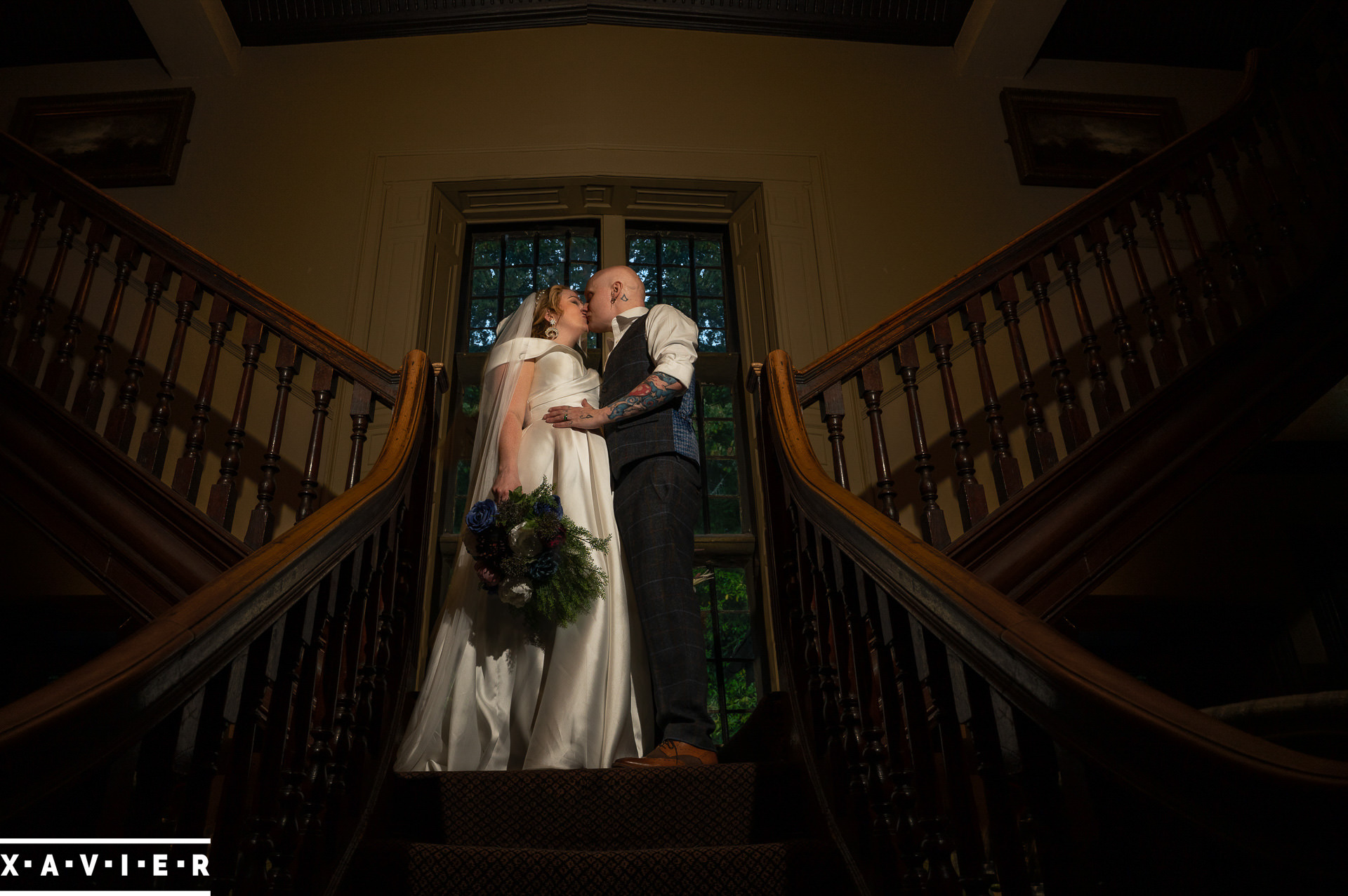 photo of bride and groom kissing on the stairs