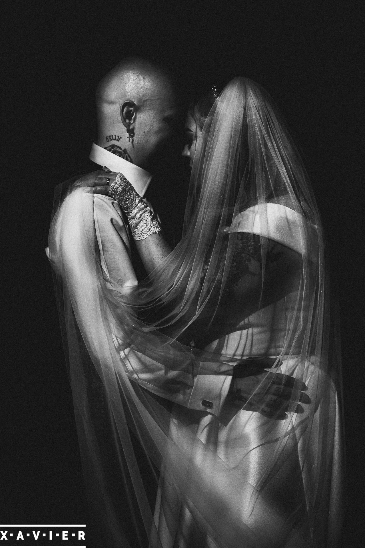 black and white photo of bride and groom holding each other
