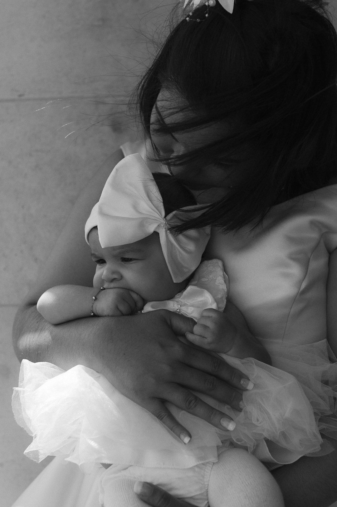 black and white image of the bride holding her baby