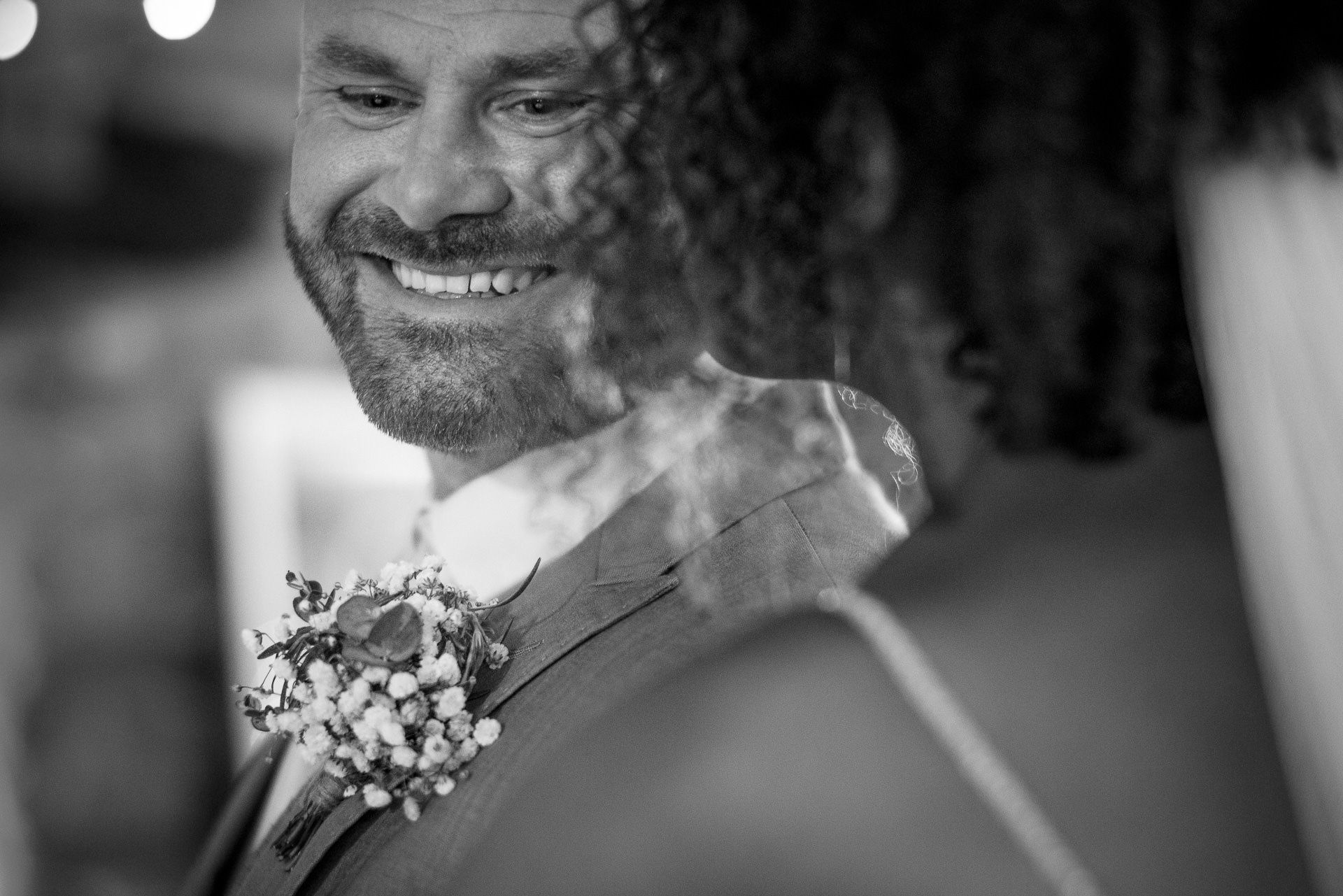 the groom smiles at his bride
