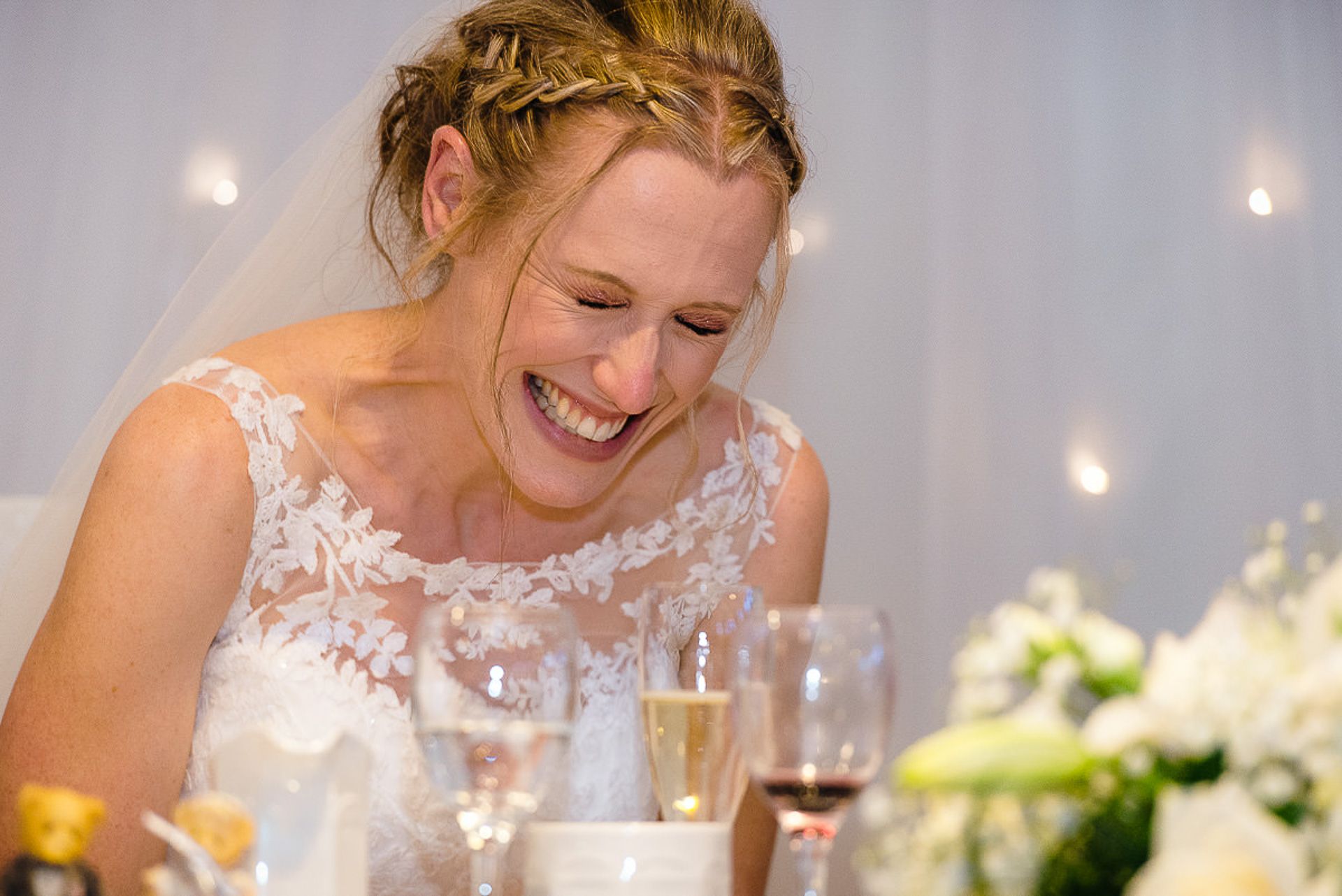 brides laughs at the speech her husband is making