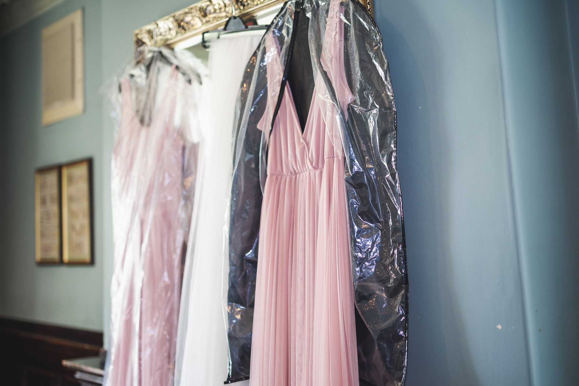 the brides and bridesmaids dress hang in reception