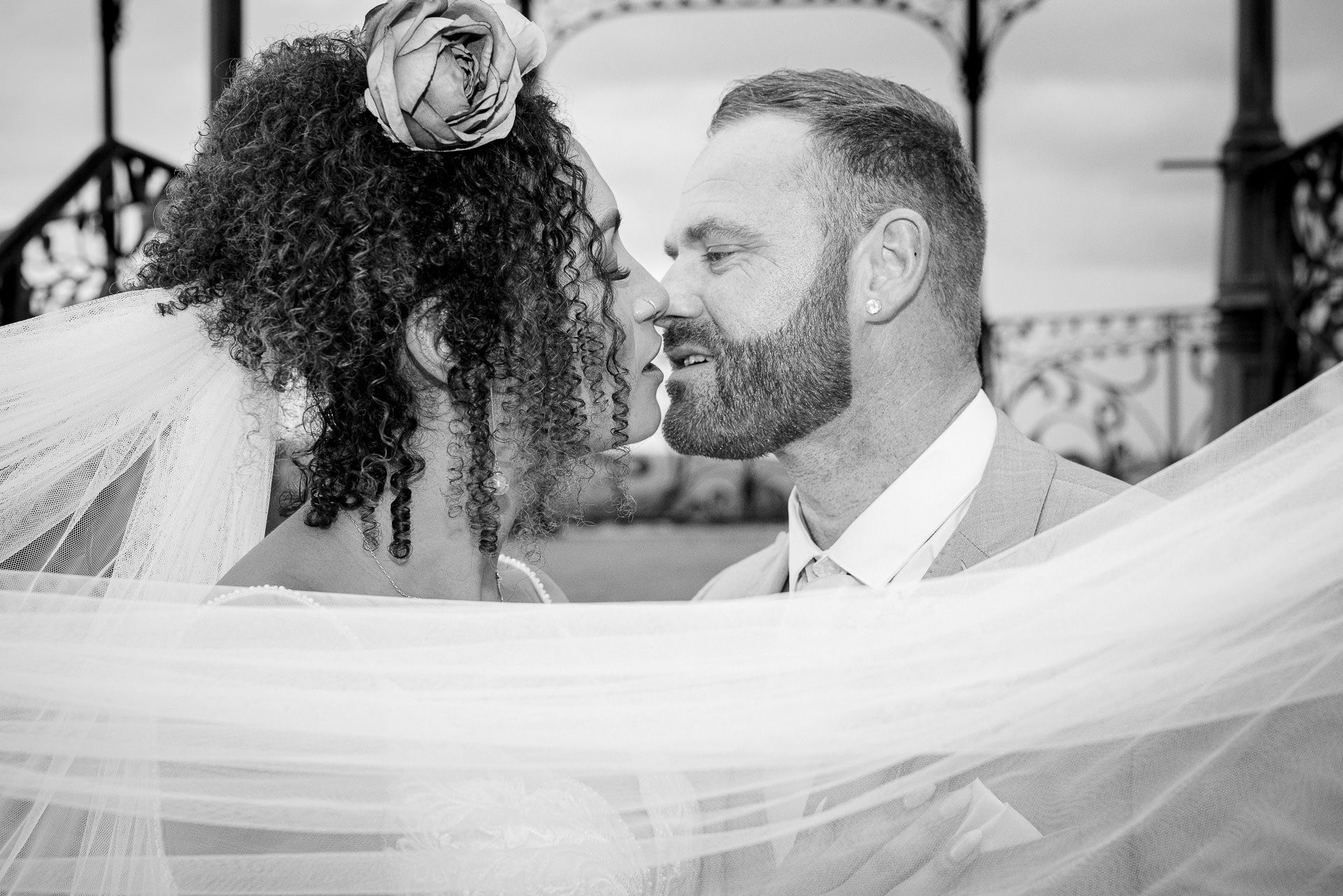 black and white image of the bride and groom about to kiss