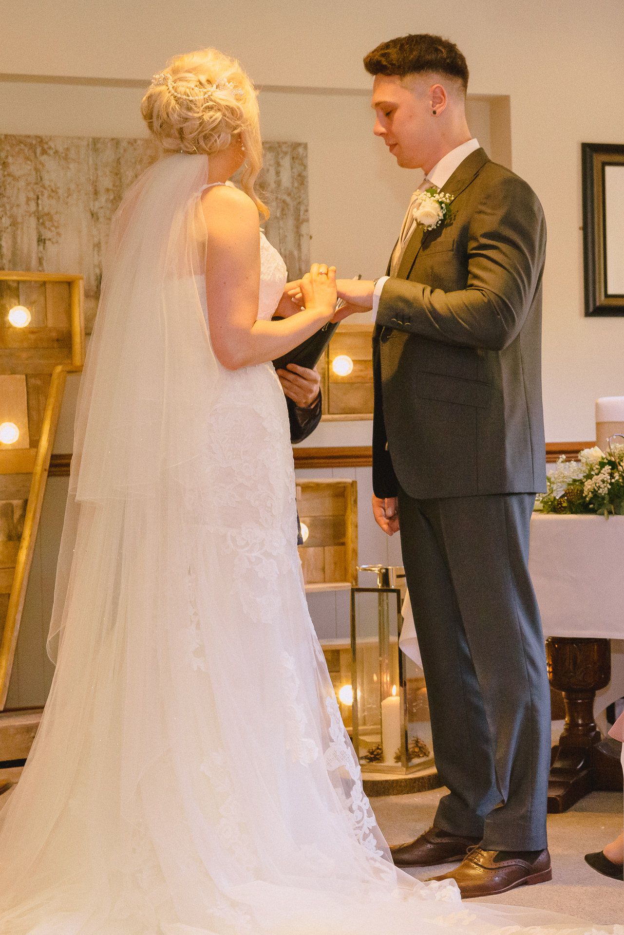 bride places the ring on the grooms finger