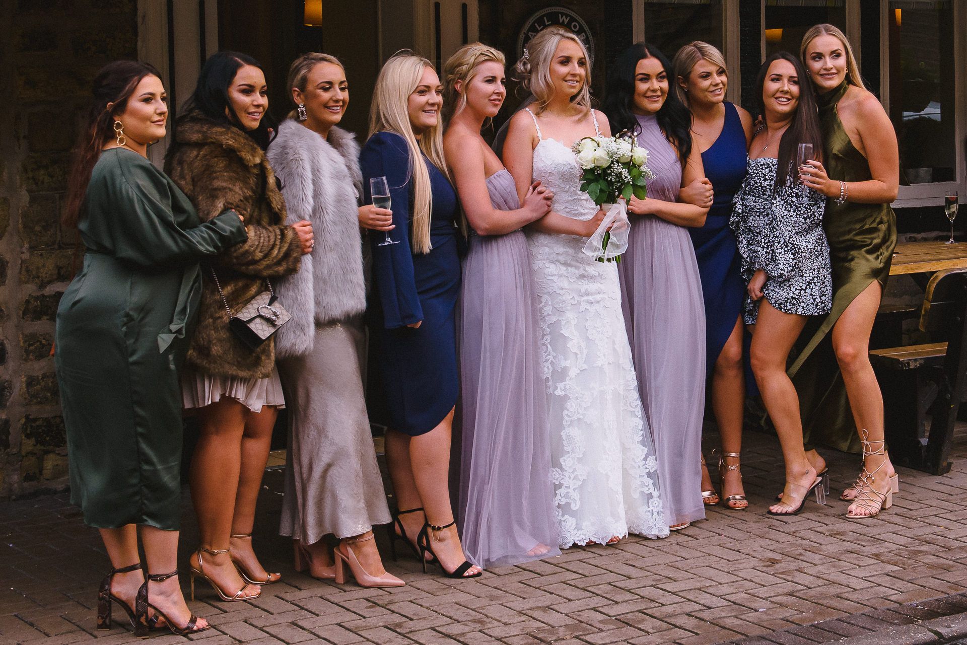 bride poses with bridesmaids and close friends