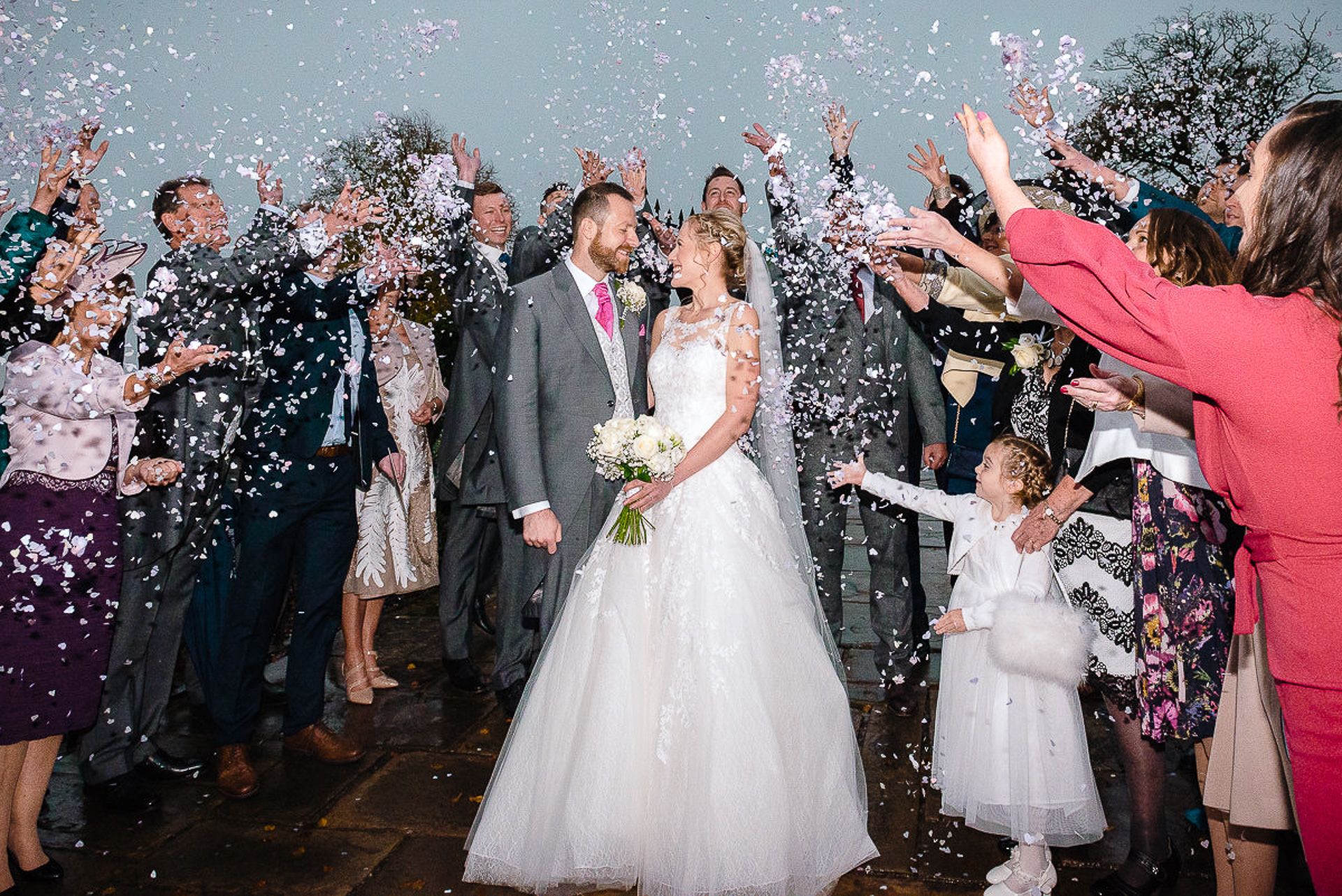 bride and groom showered with confetti