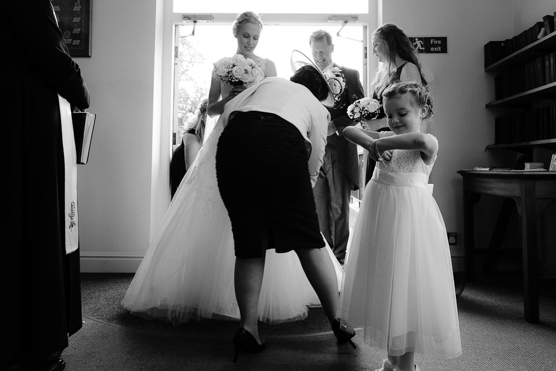 mother of the bride adjust her wedding dress