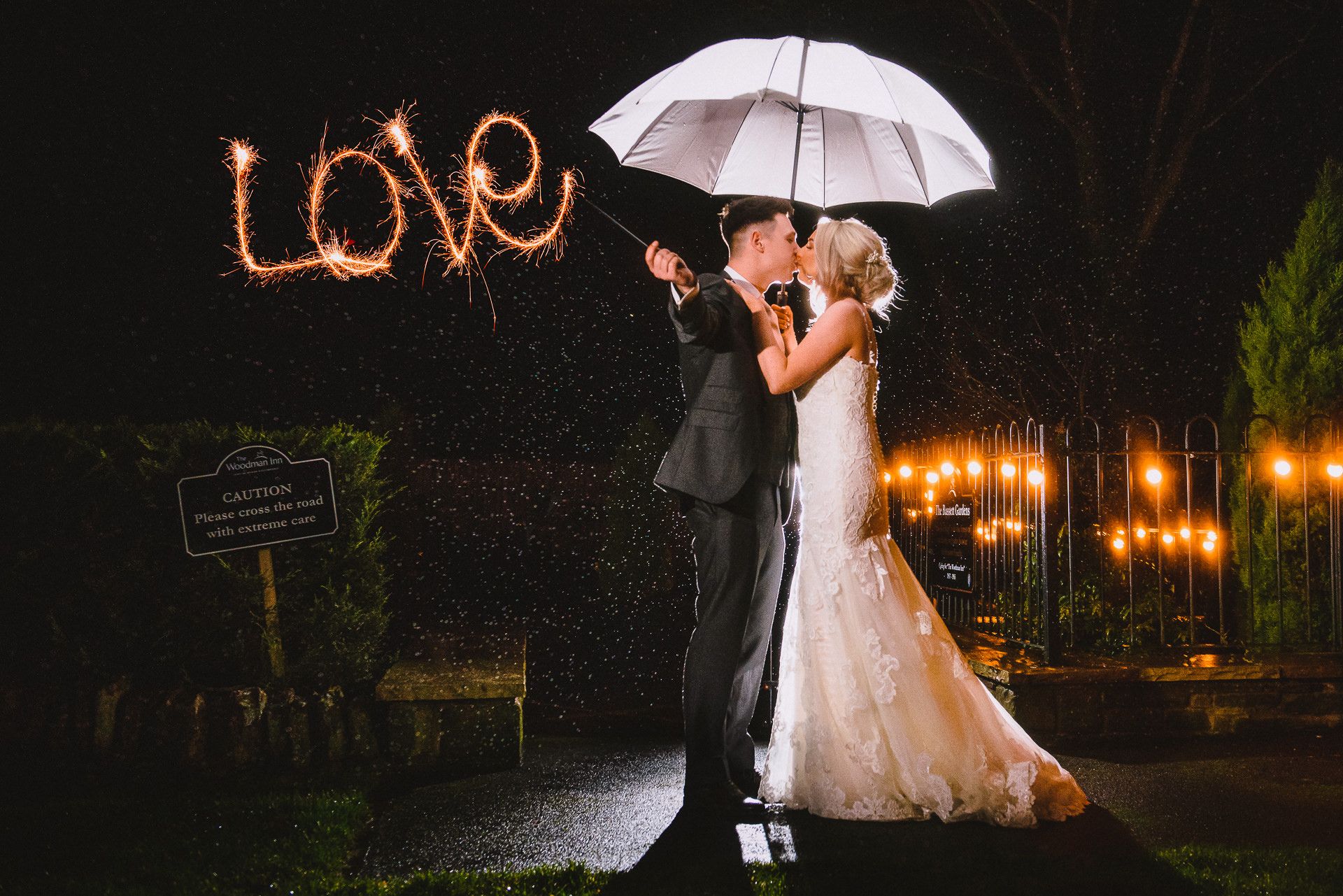 bride and groom hold love sparkler in the dark