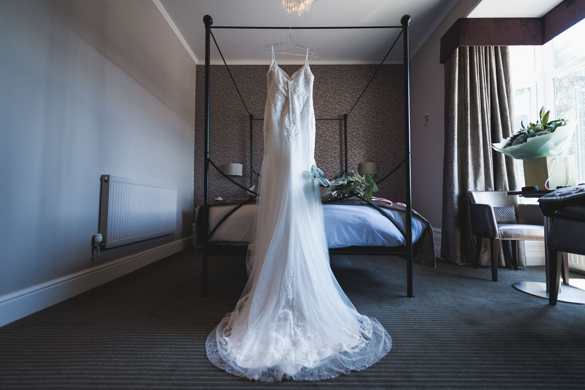 the birde's wedding dress is hanging in the bedroom