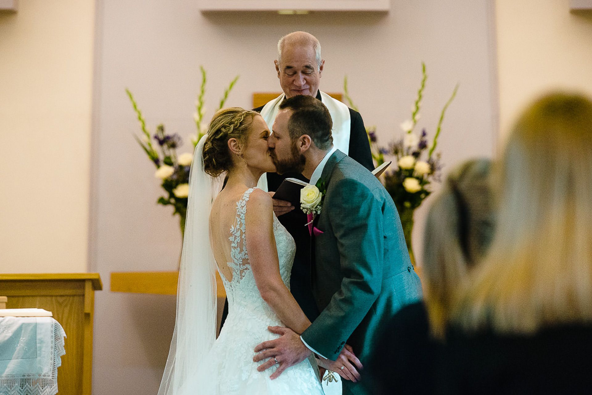 bride and groom kiss as man and wife