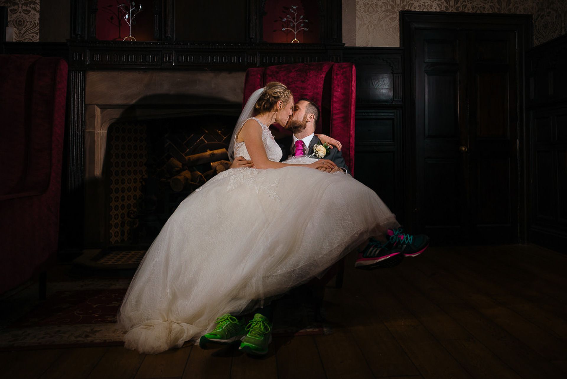 bride and groom kiss wearing running shoes