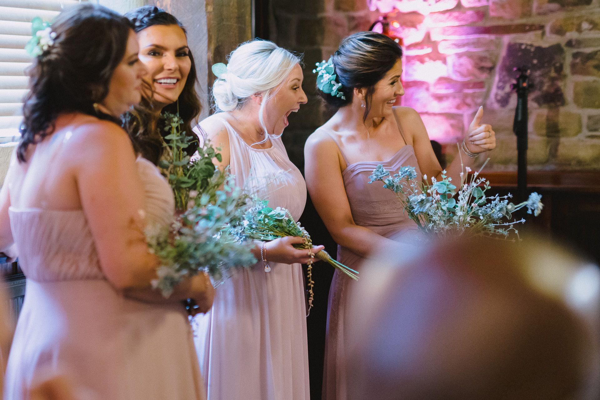 the bridesmaids show their delight as the ceremony ends