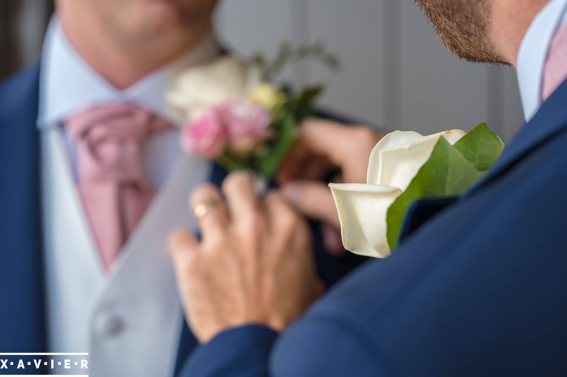 groom is having his button hole flowers attached